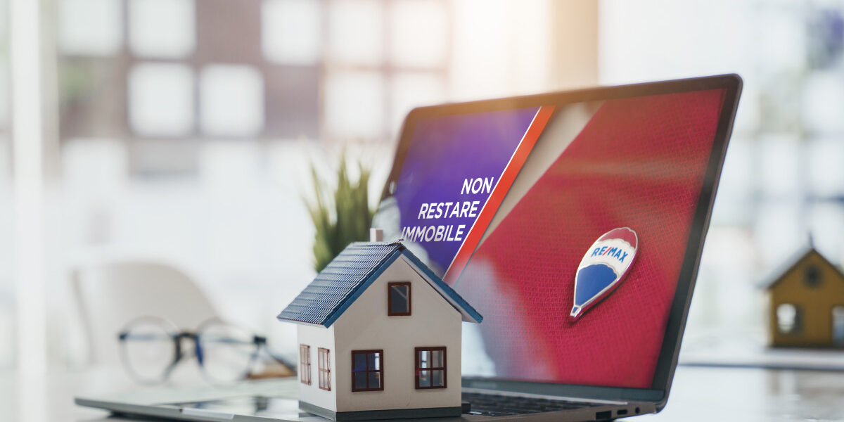 Concept per annunci immobiliari efficaci: computer con schermata in cui viene mostrato il logo e claim Replanner